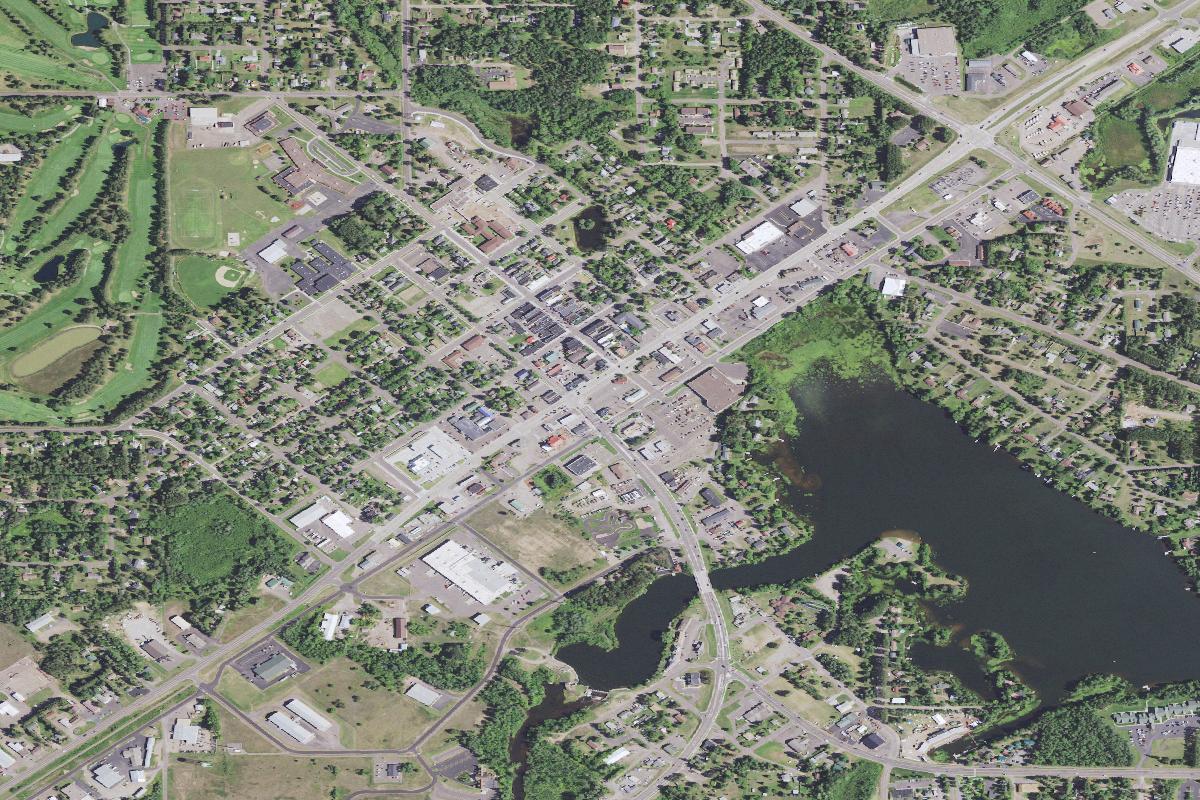 Aerial view of downtown Hayward, Wisconsin, with US Highway 63 running through it and the Namekagon River at the edge of town
